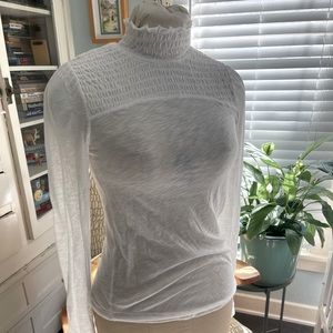 We The Free turtleneck smocked blouse.